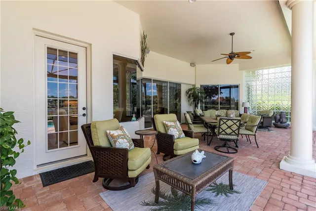 a living room with patio furniture and a window