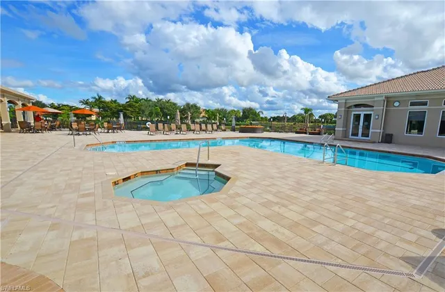 a view of a house with swimming pool and sitting area