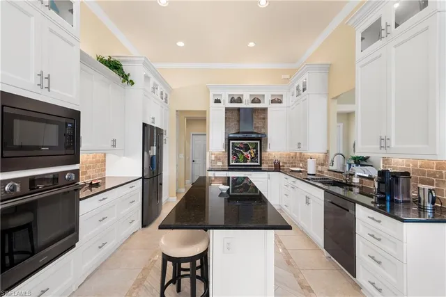 a kitchen with stainless steel appliances a stove sink microwave and cabinets
