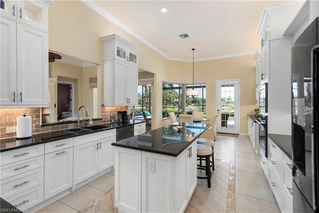 a kitchen with sink stove and cabinets