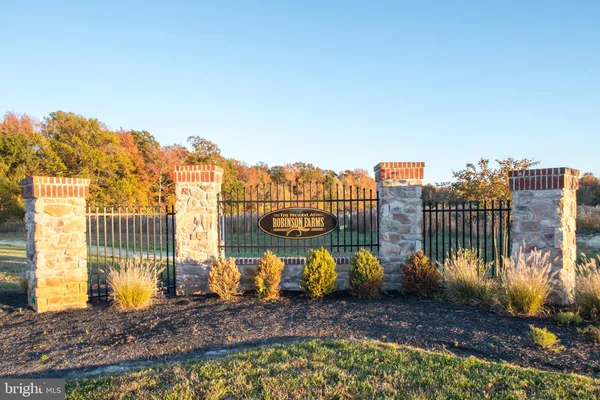 a view of a park with iron fence