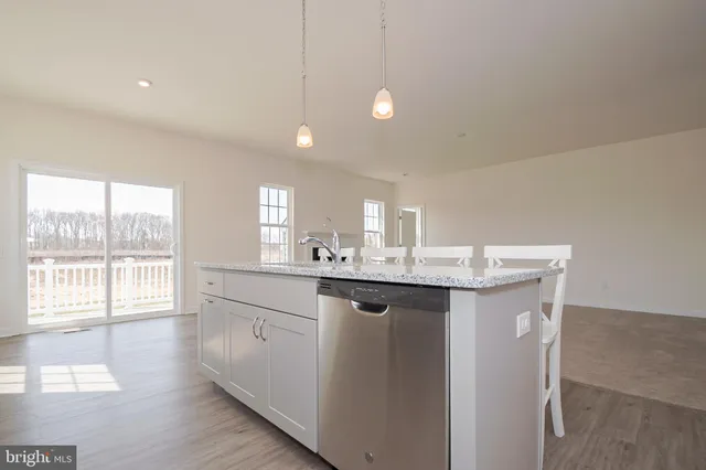 a kitchen with center island wooden floor and white appliances