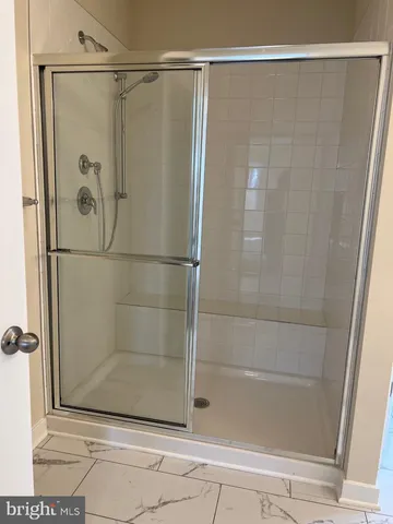 a bathroom with a glass shower door