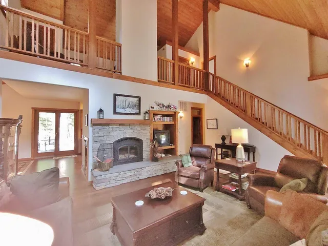 a living room with furniture a fireplace and a window