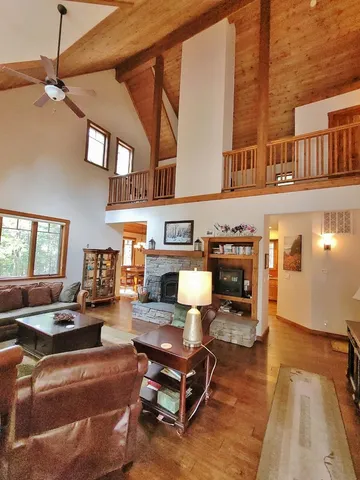 a living room with fireplace furniture and a rug