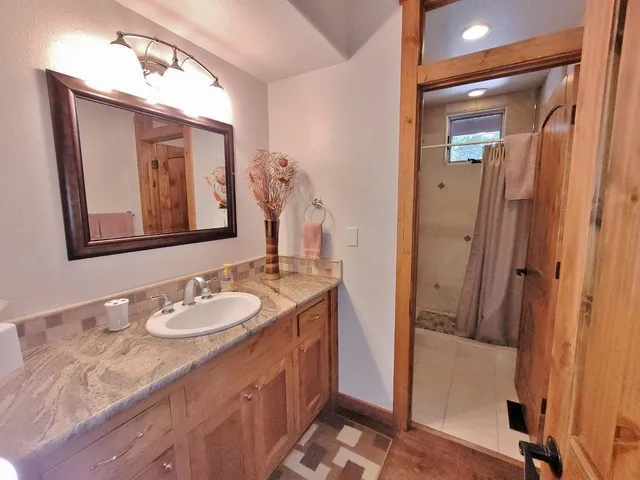 a bathroom with a sink vanity and mirror