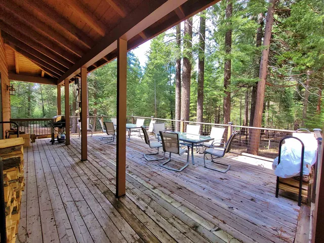 a living room with patio furniture and wooden floor