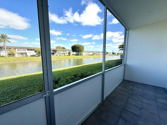 a view of a porch with furniture and a yard