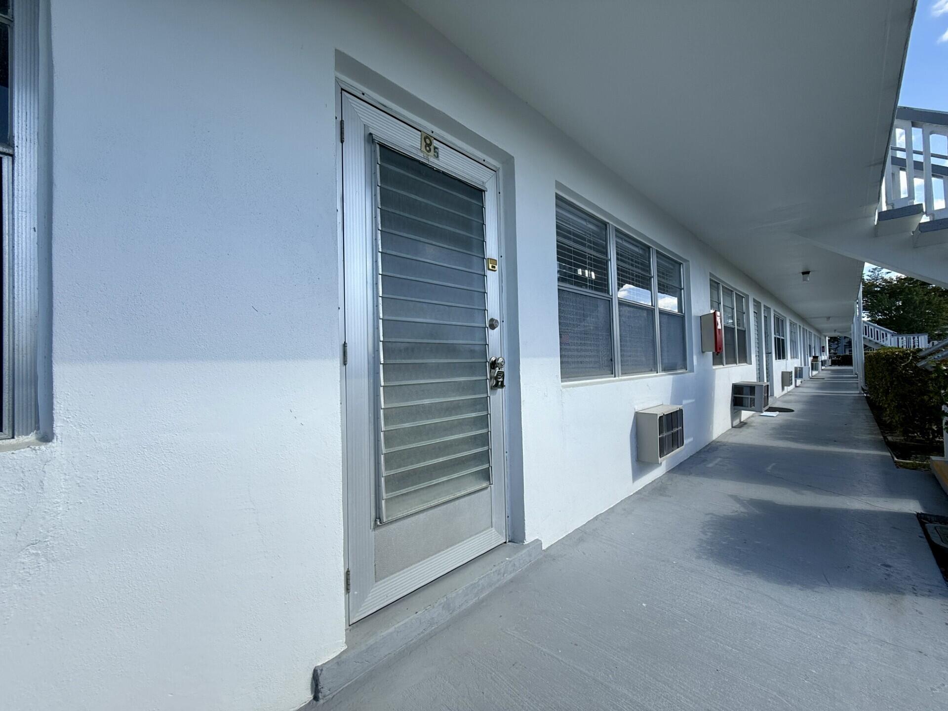 85 Berkshire D West Palm Beach, FL 33417 - Photo 12 of 17 a view of a porch with furniture and a yard