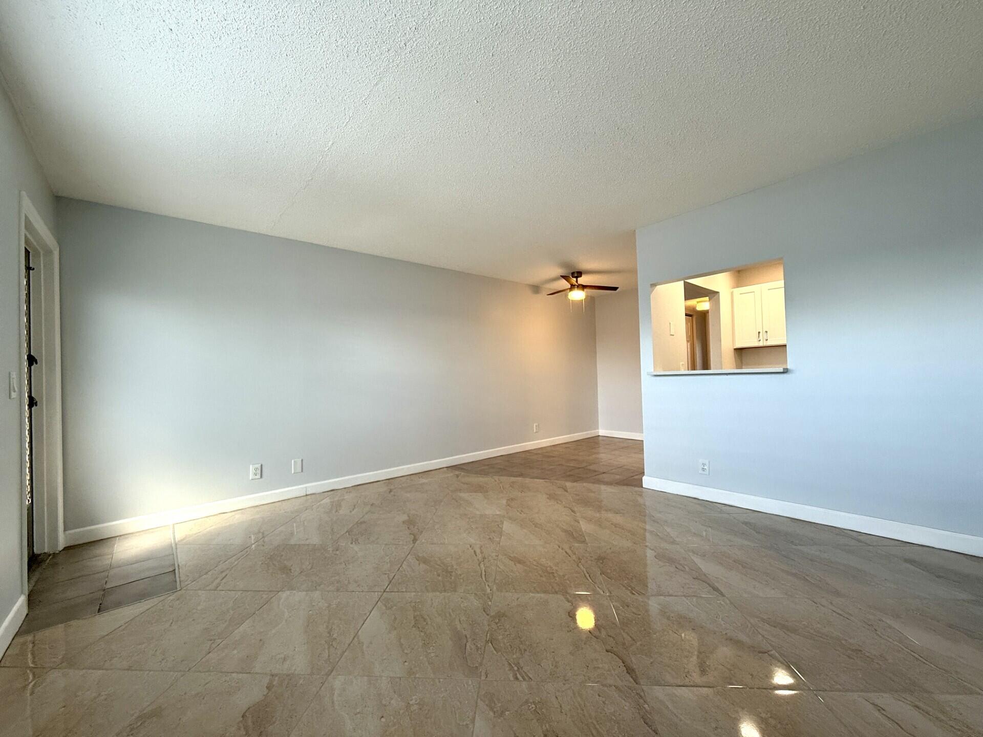 85 Berkshire D West Palm Beach, FL 33417 - Photo 6 of 17 an empty room with windows and closet