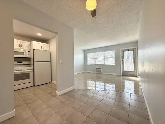 a view of a refrigerator in kitchen and wooden floor