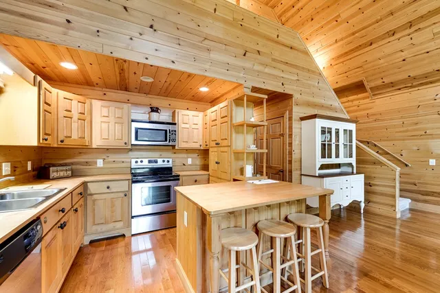 a kitchen with stainless steel appliances granite countertop a stove a sink dishwasher and a refrigerator