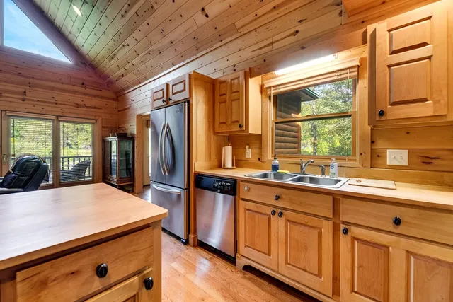 a view of a room with wooden floor and furniture