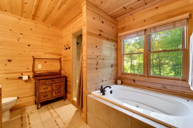 a spacious bathroom with a granite countertop sink and a large mirror