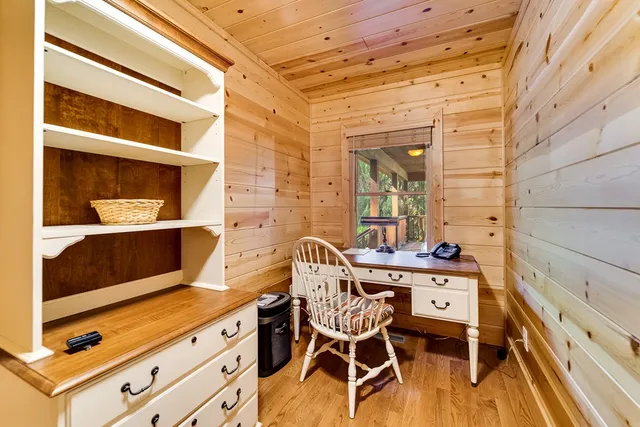 an empty room with windows and mirror