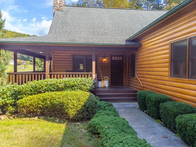 a view of a house with brick walls and a yard