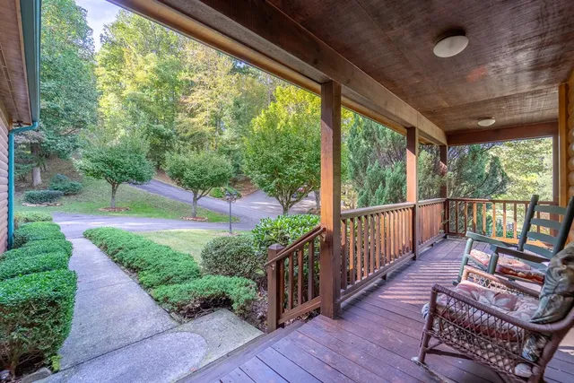 a view of a porch with furniture and a yard