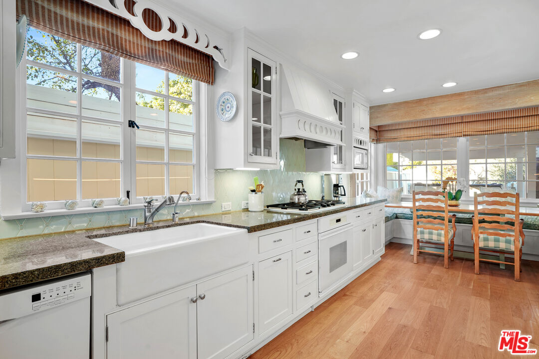 23422 Malibu Colony Road, Unit 98 Malibu, CA 90265 - Photo 16 of 53 a kitchen with granite countertop a sink and white cabinets
