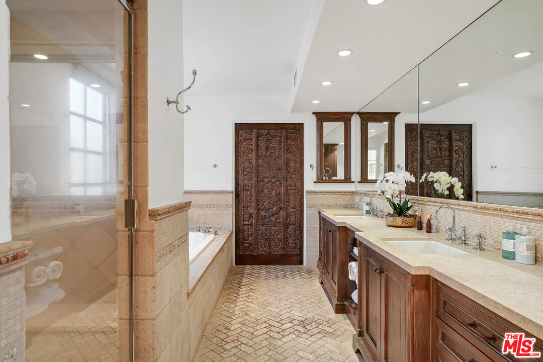 23422 Malibu Colony Road, Unit 98 Malibu, CA 90265 - Photo 25 of 53 a spacious bathroom with a double vanity sink a mirror and a shower