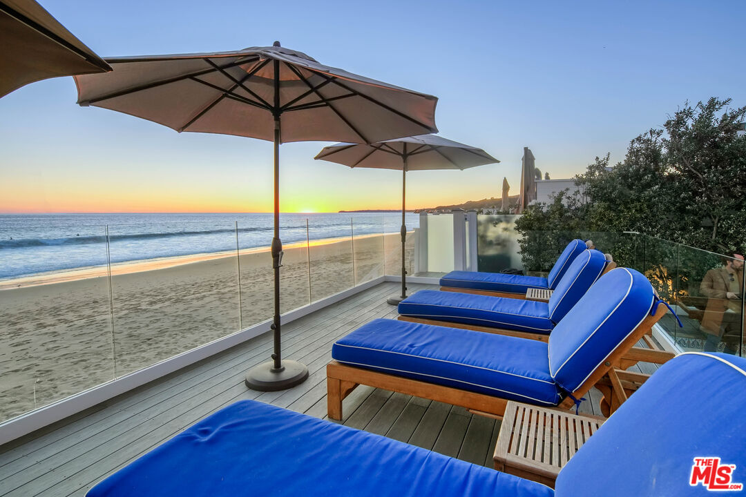 23422 Malibu Colony Road, Unit 98 Malibu, CA 90265 - Photo 3 of 53 a view of a wooden deck with a bench