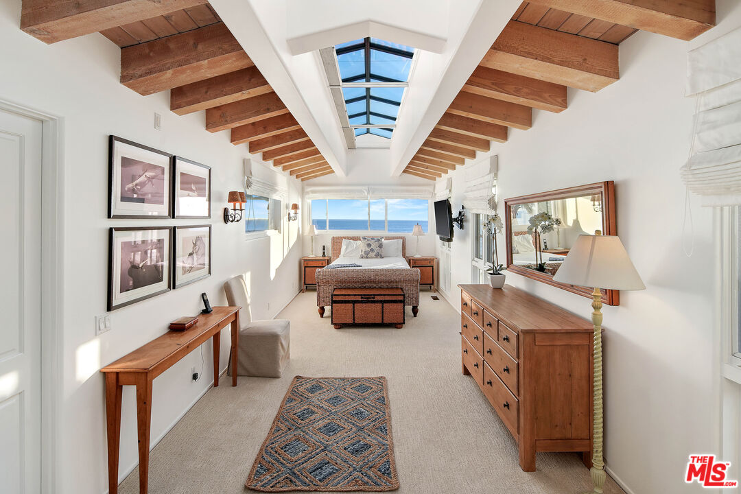 23422 Malibu Colony Road, Unit 98 Malibu, CA 90265 - Photo 34 of 53 a living room with furniture and a chandelier