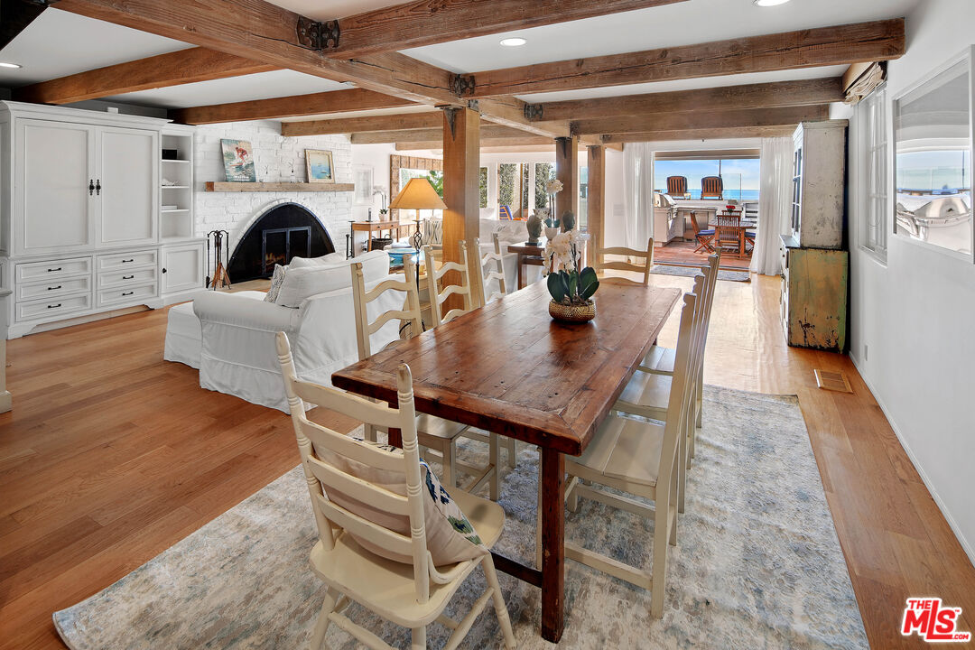 23422 Malibu Colony Road, Unit 98 Malibu, CA 90265 - Photo 6 of 53 a dining room with furniture and chandelier