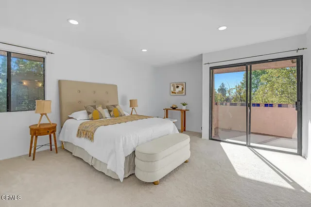 a bedroom with a bed and large glass window
