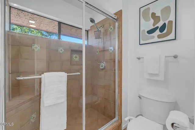 a bathroom with a shower and toilet