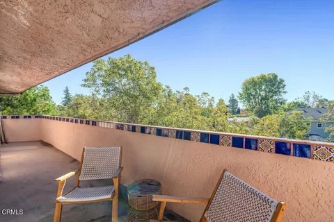 a view of balcony with wooden floor and outdoor seating