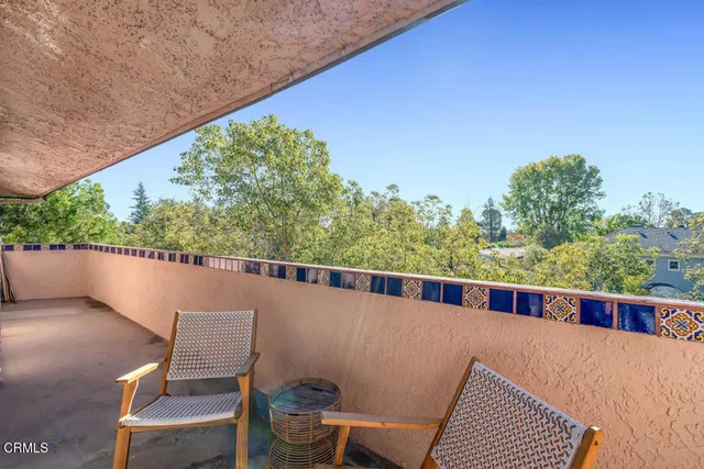 a view of balcony with wooden floor and outdoor seating