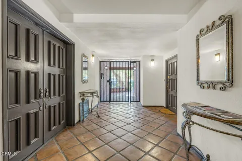 a view of a hallway with entryway and dining area