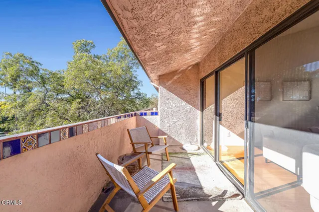 a view of a balcony with chairs