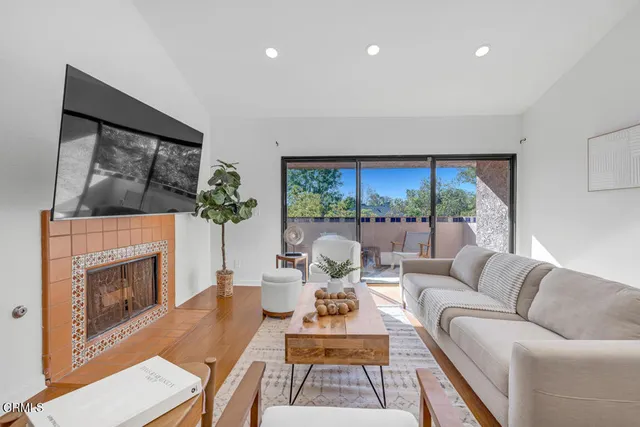 a living room with furniture and a fireplace