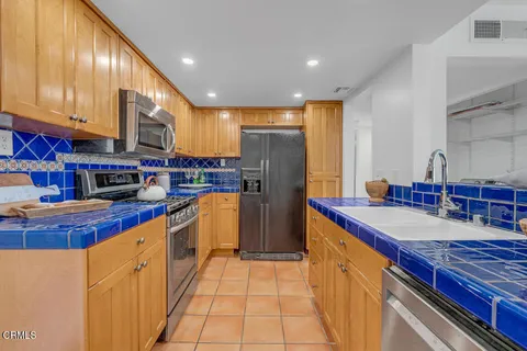 a kitchen with stainless steel appliances granite countertop a sink and cabinets
