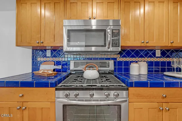 a stove top oven sitting inside of a kitchen