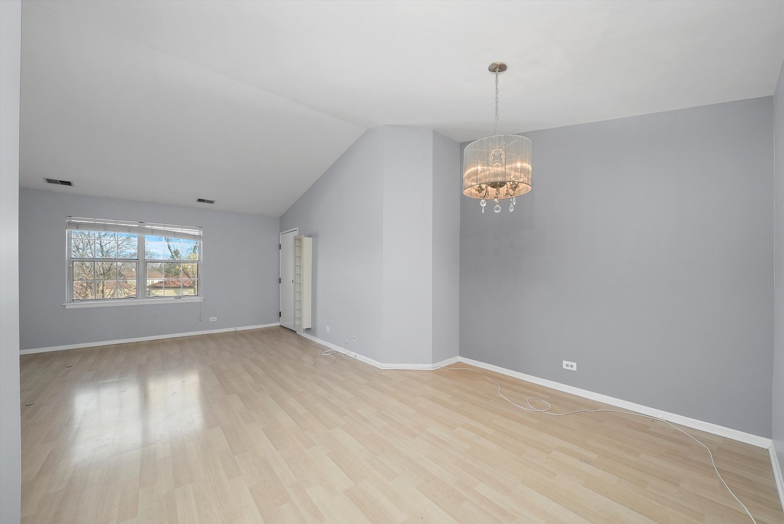 152 East Winchester Road, Unit E Libertyville, IL 60048 - Photo 11 of 24 an empty room with wooden floor and windows