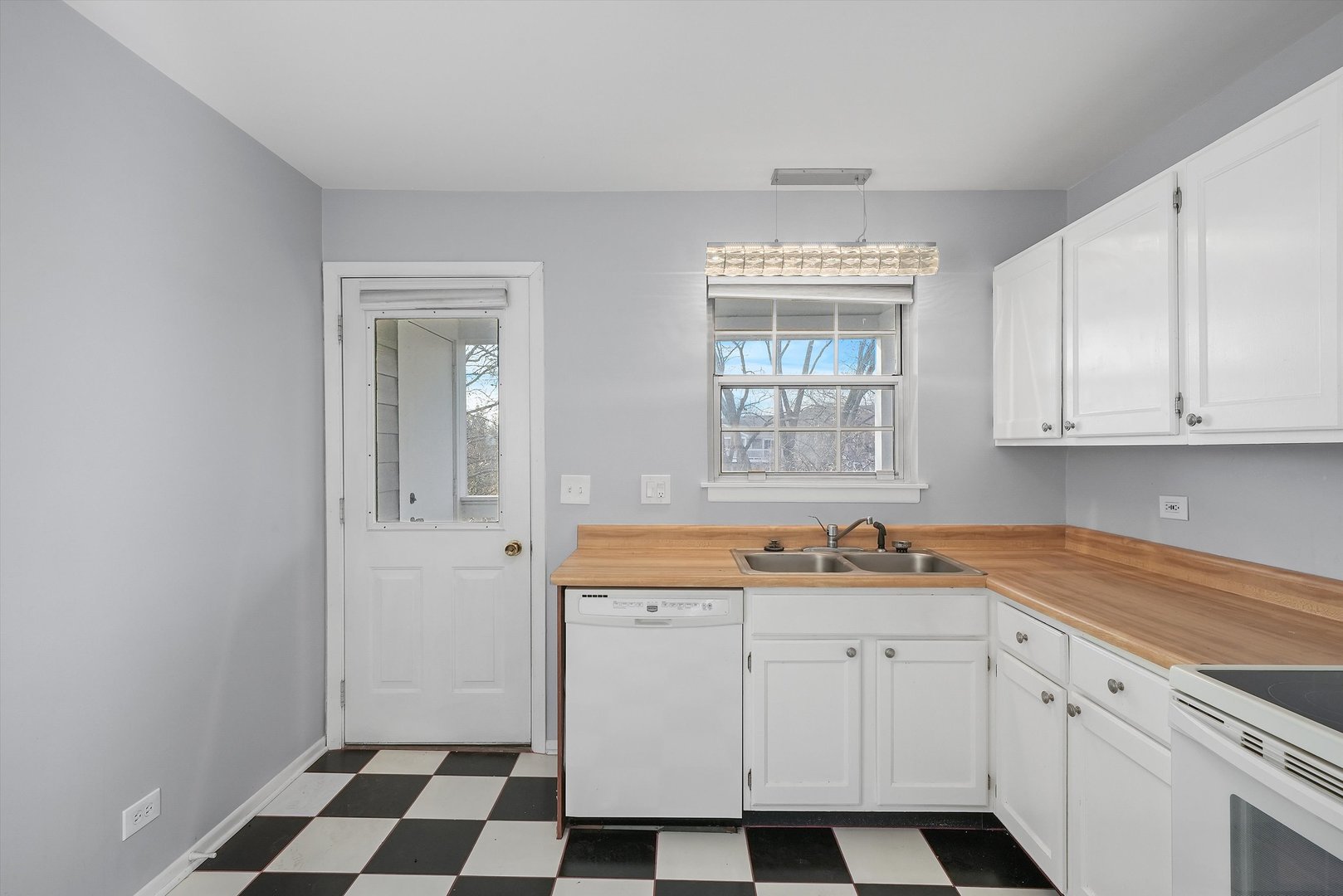 152 East Winchester Road, Unit E Libertyville, IL 60048 - Photo 13 of 24 a kitchen with a sink and cabinets