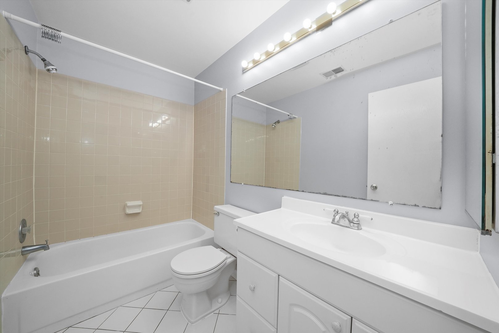 152 East Winchester Road, Unit E Libertyville, IL 60048 - Photo 21 of 24 a bathroom with a sink a toilet and shower