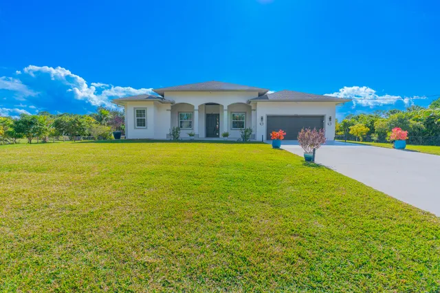 a front view of house with yard and seating area