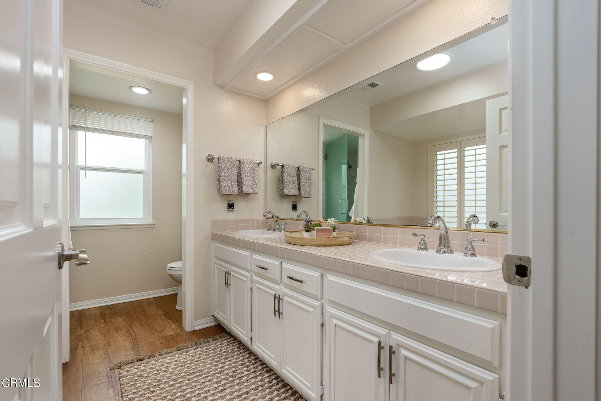 2281 Southern Hill Drive Oxnard, CA 93036 - Photo 17 of 29 a bathroom with a double vanity sink a mirror and a shower