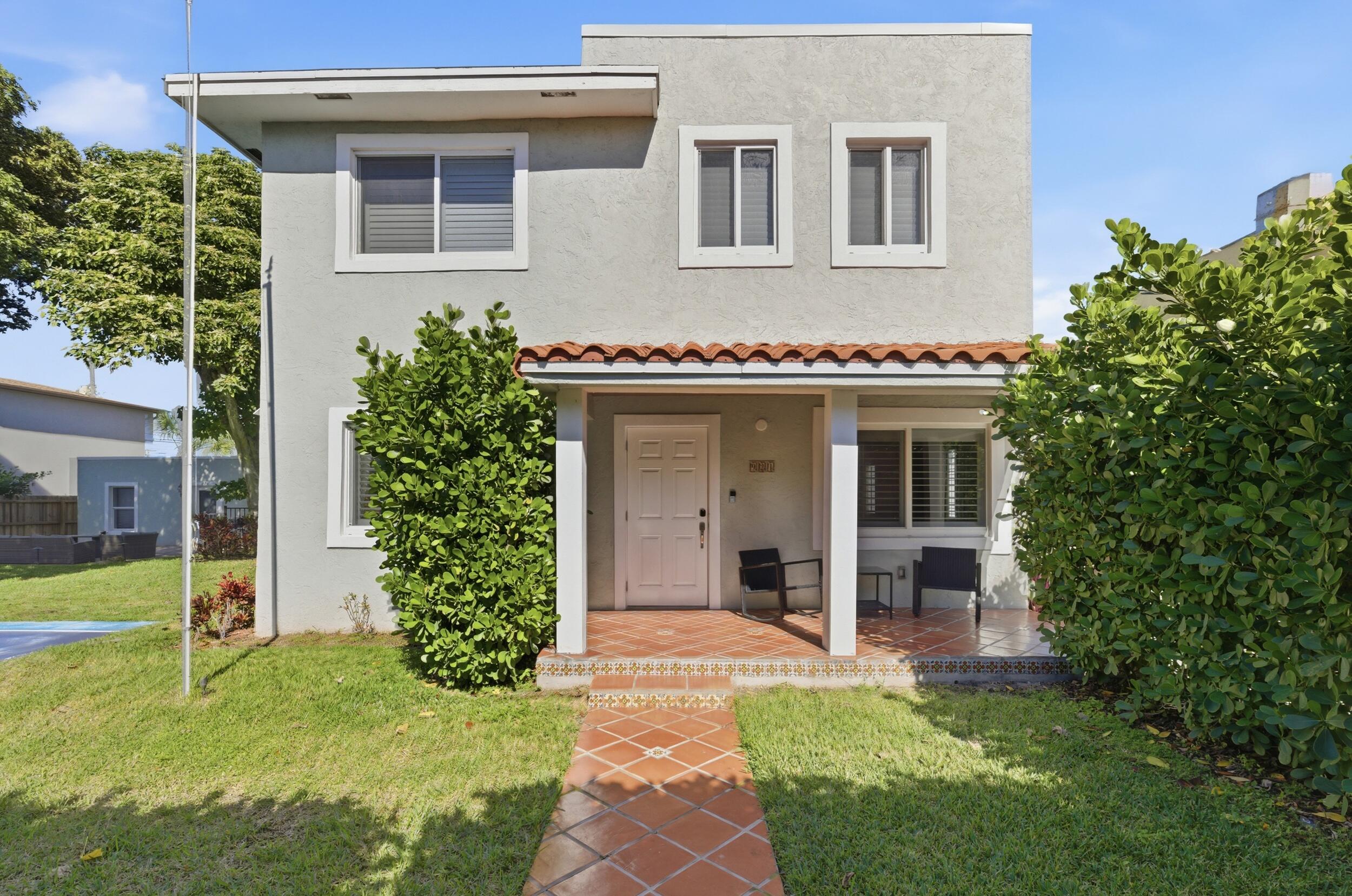 921 Ortega Road West Palm Beach, FL 33405 - Photo 58 of 60 a front view of a house with a garden