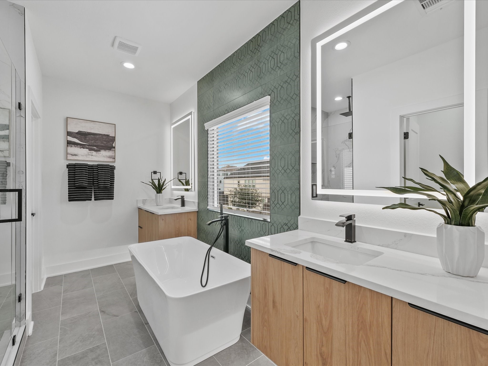 2592 West Tidwell Road Houston, TX 77091 - Photo 16 of 23 a spacious bathroom with a bathtub sink and mirror