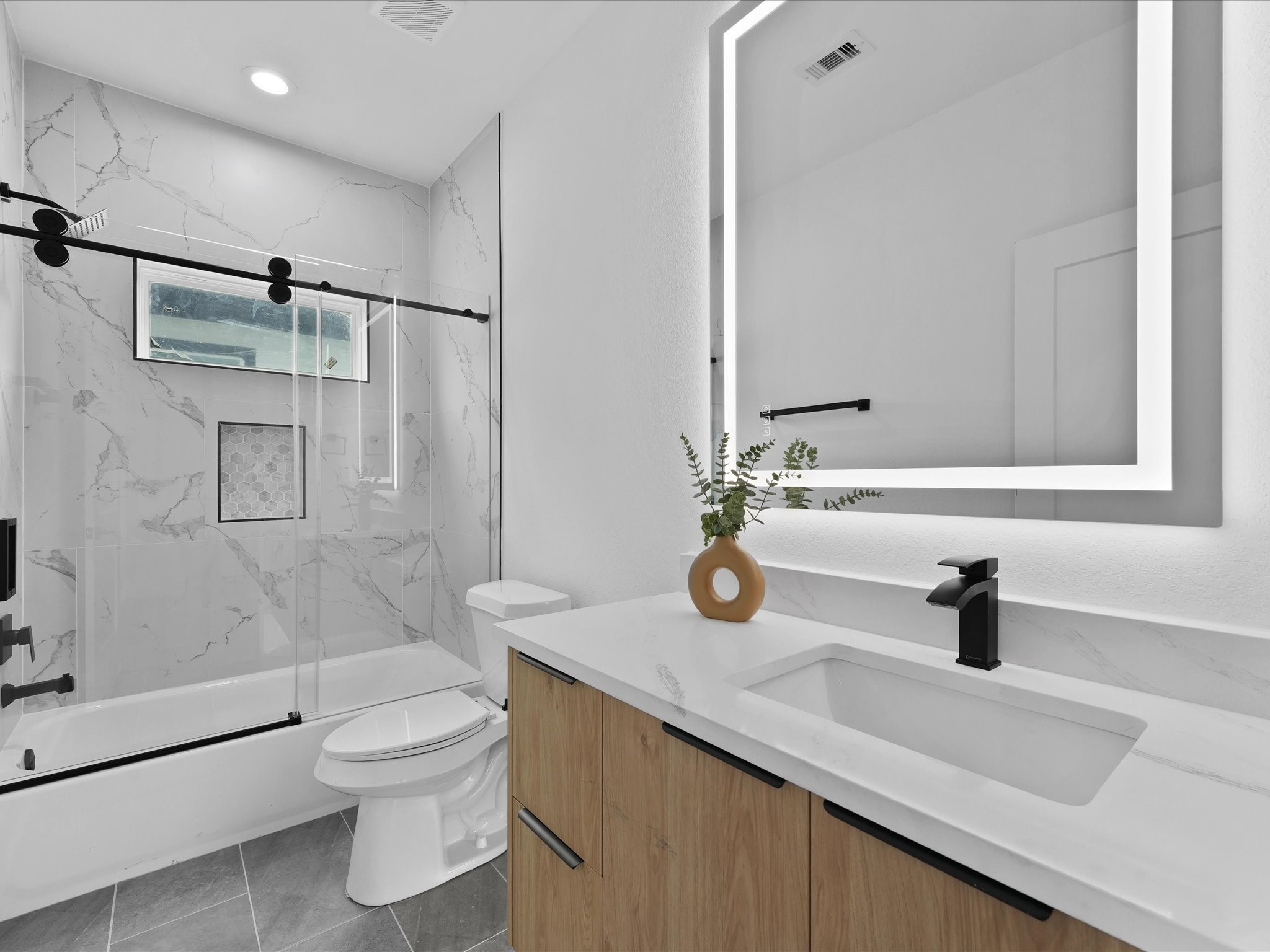 2592 West Tidwell Road Houston, TX 77091 - Photo 20 of 23 a bathroom with a sink and a mirror