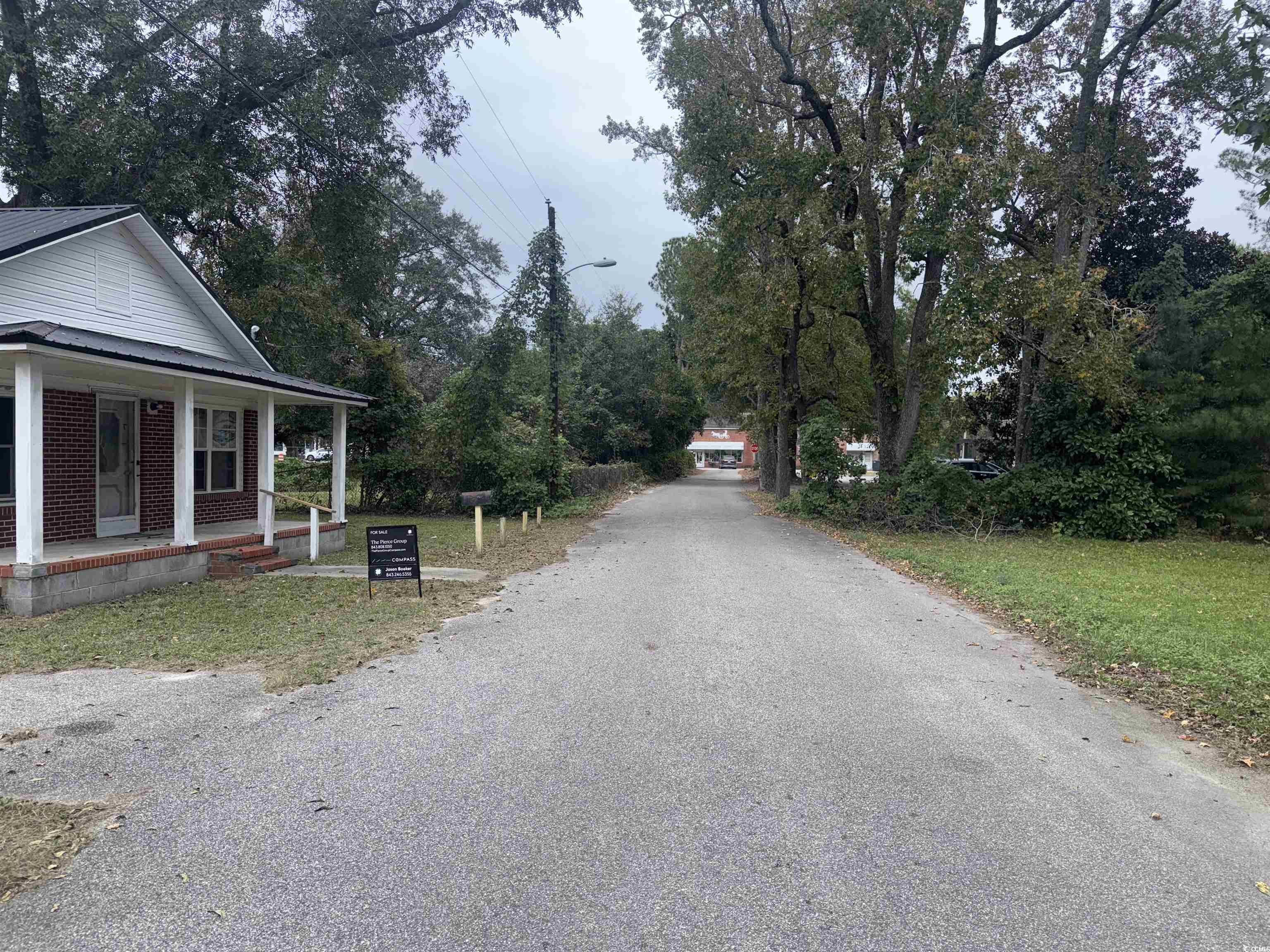 106 Raeford Street Mullins, SC 29574 - Photo 3 of 15 View of asphalt road featuring street lights