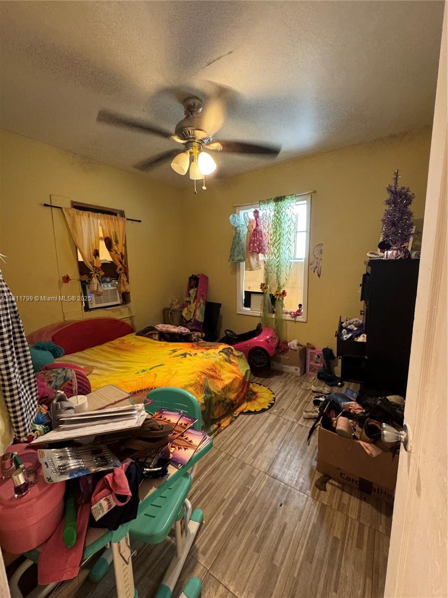 151 Northwest 64th Street Miami, FL 33150 - Photo 11 of 13 a room with furniture and a flat screen tv