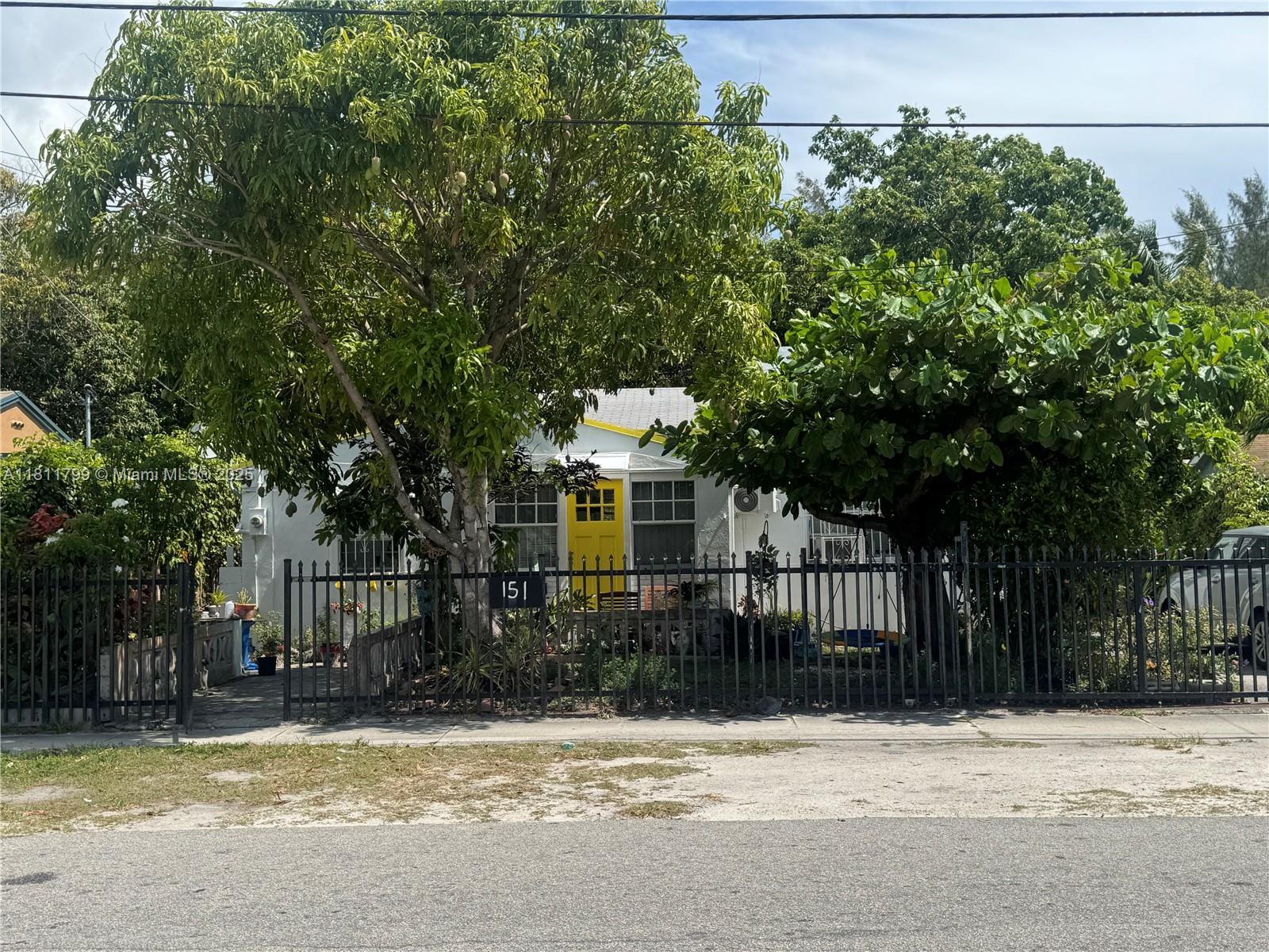 151 Northwest 64th Street Miami, FL 33150 - Photo 2 of 13 a house that has a tree in front of it