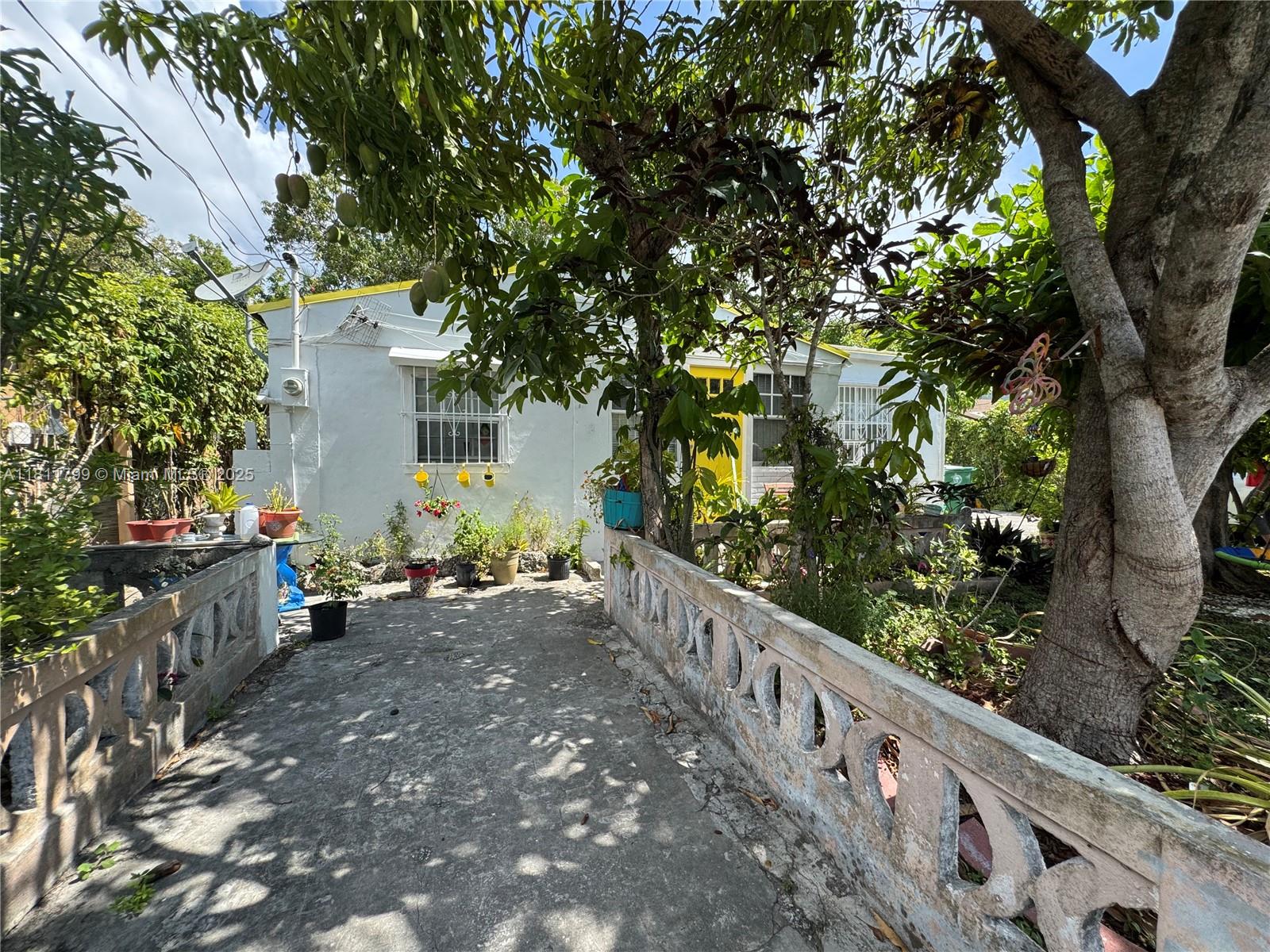 151 Northwest 64th Street Miami, FL 33150 - Photo 3 of 13 a view of a bench in a backyard