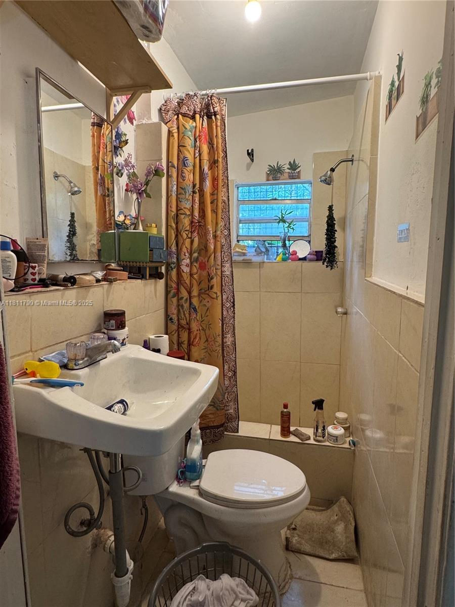 151 Northwest 64th Street Miami, FL 33150 - Photo 6 of 13 a bathroom with a sink toilet and shower