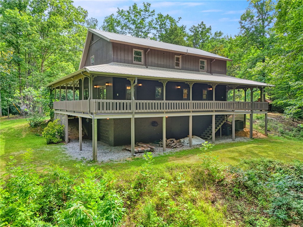 120 Patterson Ridge Road Salem, SC 29676 - Photo 28 of 46 A grand elevated home with an inviting wrap-around porch set amidst a tranquil wooded landscape.