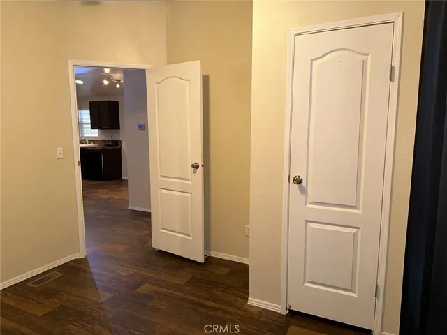 an empty room with wooden floor